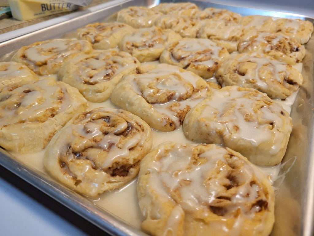 Homemade Cinnamon Rolls with Icing Dripping and Still Warm